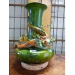 A MING STYLE GREEN GROUND POTTERY BOTTLE VASE ENTWINED BY A YELLOW SPLASHED DRAGON. H 37cms.