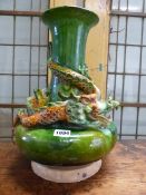 A MING STYLE GREEN GROUND POTTERY BOTTLE VASE ENTWINED BY A YELLOW SPLASHED DRAGON. H 37cms.