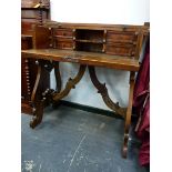 AN ITALIAN DROP FLAP WRITING TABLE, THE INTERIOR TWO SHELVES FLANKED BY PAIRS OF DRAWERS, THE SCROLL