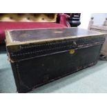 AN ANTIQUE BRASS EDGED AND CLOSE NAILED LEATHER COVERED CAMPHORWOOD TWO HANDLED TRUNK. W 93cms.