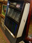 A SEEBURG JUKE BOX TO PLAY A SELECTION OF FORTY EIGHT DISCS WITH THEIR TITLES BEHIND GLASS ABOVE A
