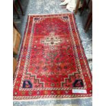 A PERSIAN TRIBAL RUG 202 x 133 cm TOGETHER WITH A TIBETAN RUG 182 x 96cm (2)