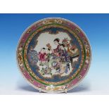 A CHINESE STYLE RUBY BACKED DISH PAINTED WITH TWO LADIES AND TWO CHILDREN WATCHING A CAT