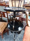 A PAIR OF BLACK DISHED CIRCULAR TABLES WITH GILT DETAILS ON THE SCROLLING TRIPOD LEGS. Dia. 51 x H