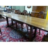 AN ARTS AND CRAFTS STYLE OAK REFECTORY TABLE ON DOUBLE SQUARE PILLAR END SUPPORTS. W 271 X D 62 X