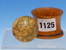 A J G KLINGER TERRESTIAL GLOBE REVOLVING IN A WAISTED CYLINDRICAL TREEN CUP, THE GLOBE. Dia. 4cms.