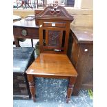 A VICTORIAN MAHOGANY HALL CHAIR, THE SWAN NECK TOP RAIL ABOVE A FLOWER STEM BACK PANEL, THE TAPERING