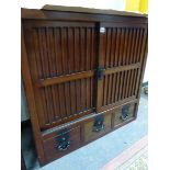 A CHINESE HARDWOOD SIDE CABINET WITH TWO BLIND SLATTED DOORS ENCLOSING SHELVES OVER THREE DRAWERS. W