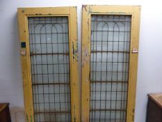 FOUR COPPER GLAZED DOORS, EACH WITH THREE HORIZONTAL BARS ACROSS THE GLASS INTO THE PAINTED