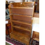 A FRUITWOOD (OLIVE?) WATERFALL BOOK CASE, THE FIVE SHELVES ABOVE A LIDDED COMPARTMENT. W 77 x D 34 x