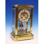A MANTEL CLOCK IN GLAZED BRASS CASE STRIKING ON A BELL, THE PENDULUM MERCURY COMPENSATED, THE