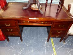 A MAHOGANY PEDESTAL DESK, THE TOP INSET WITH RED LEATHER, THE DRAWER ABOVE THE KNEEHOLE FLANKED BY