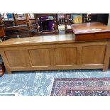 AN ARTS AND CRAFTS OAK COFFER WITH FOUR PANELLED FRONT. W 150 x D 41 x H 48cms.