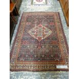 AN ANTIQUE PERSIAN RUG 190 x 136cm