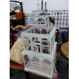 A WOODEN AND WIREWORK BIRD CAGE PAINTED WHITE