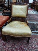 A LATE VICTORIAN ROSEWOOD SHOW FRAME NURSING CHAIR, THE ROSETTE AND RIBBON CARVED TOP RAIL ABOVE AN