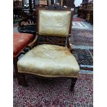 A LATE VICTORIAN ROSEWOOD SHOW FRAME NURSING CHAIR, THE ROSETTE AND RIBBON CARVED TOP RAIL ABOVE AN