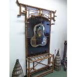 AN ANTIQUE BAMBOO AND BLACK CHINOISERIE LACQUER HALL STAND WITH CENTRAL QUATREFOIL MIRROR. W 140 x
