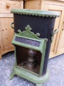 A PETROLUX GREEN ENAMELLED CAST STOVE WITH TWO HANDLES TO THE BLACK SIDES