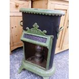 A PETROLUX GREEN ENAMELLED CAST STOVE WITH TWO HANDLES TO THE BLACK SIDES