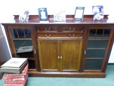 A MAPLE AND CO EDWARDIAN MAHOGANY SIDE CABINET, THE THREE DRAWERS OVER PANELLED CUPBOARDS BETWEEN