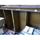 AN OAK OPEN BOOKCASE LACKING SHELVES.