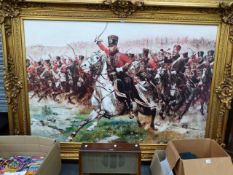 A LARGE DECORATIVE PICTURE DEPICTING CAVALRY AT WATERLOO IN SWEPT GILT FRAME. THE FRAME 221 x