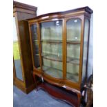 AN EDWARDIAN MAHOGANY INLAID DISPLAY CABINET ON CABRIOLE LEGS. W 132 X D 44 X H 183cms.