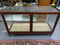 A FARLEY GLAZED MAHOGANY SHOP COUNTER WITH A RABONE BRASS YARD MEASURE TO THE TOP EDGE ABOVE THE DOO