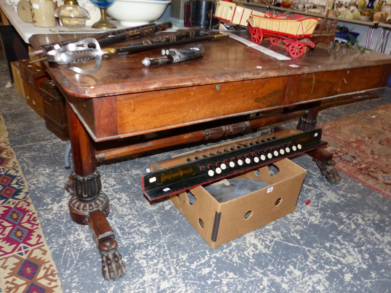 AN EARLY VICTORIAN ROSEWOOD WRITING TABLE WITH TWO DRAWERS, THE OCTAGONAL COLUMNS ATR EACH END FL