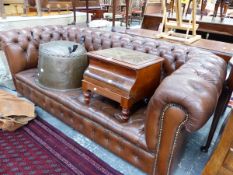 A BUTTONED BROWN LEATHER CHESTERFIELD ON BUN FEET. W 195cms.