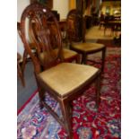A SET OF EIGHT GEORGIAN STYLE MAHOGANY DINING CHAIRS INCLUDING TWO WITH ARMS, THE OVAL BACKS CARVED