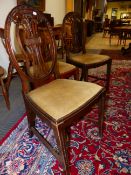 A SET OF EIGHT GEORGIAN STYLE MAHOGANY DINING CHAIRS INCLUDING TWO WITH ARMS, THE OVAL BACKS CARVED