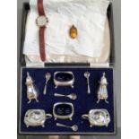 A HALLMARKED SILVER CASED SIX PART CRUET SET COMPLETE WITH FOUR SILVER SPOONS, TOGETHER WITH A