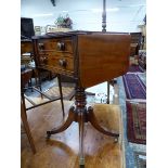 A REGENCY MAHOGANY FLAP TOP TWO DRAWER TABLE ON TURNED COLUMN, THE REEDED LEGS DOWNSWEPT TO BRASS C