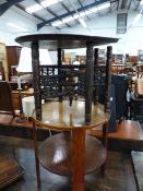 AN OAK TWO TIER CIRCULAR TABLE. Dia. 49cms. TOGETHER WITH AN EASTERN BRASS TRAY ON SIX LEGGED