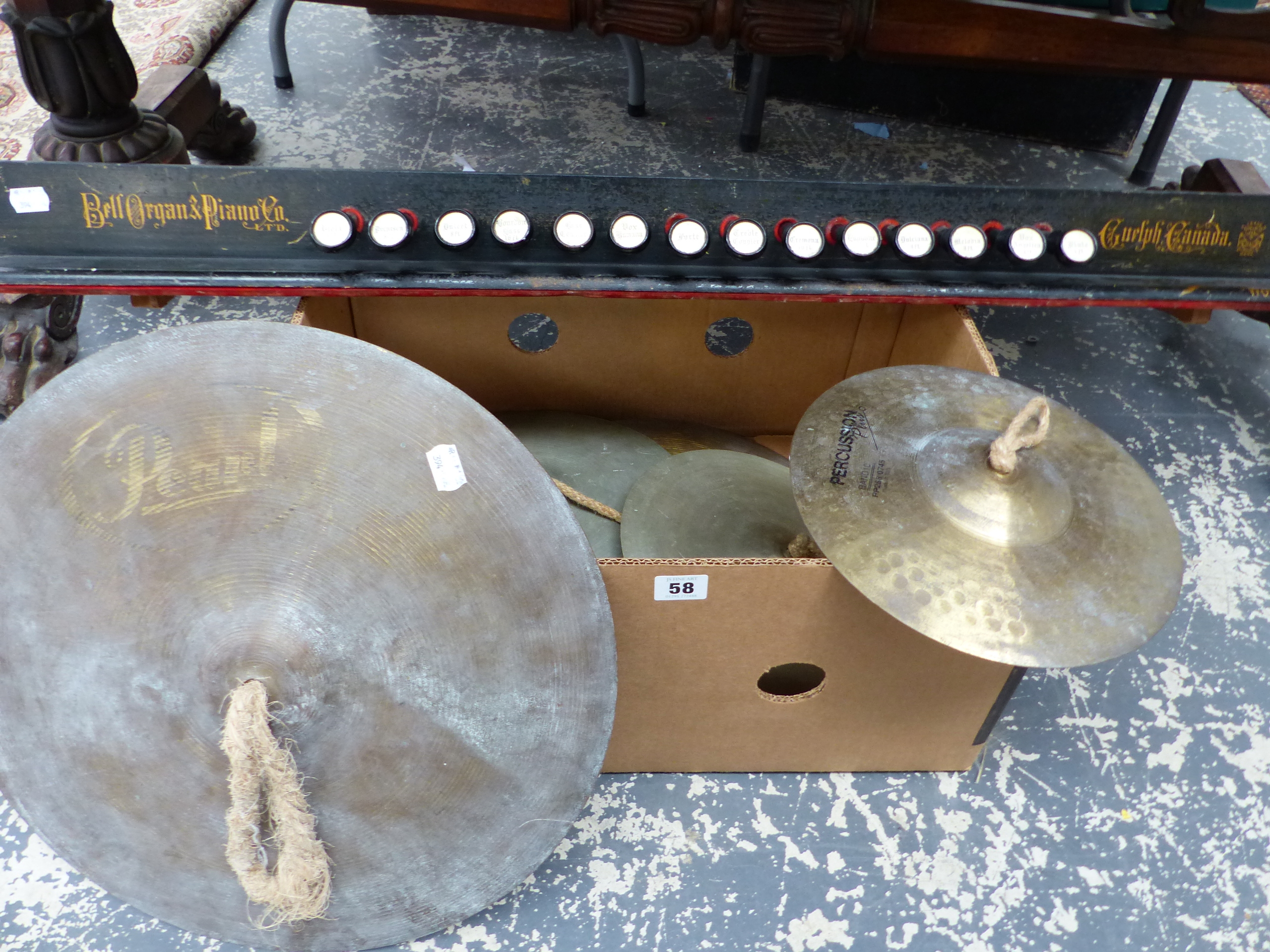 VARIOUS CYMBALS AND A BANK OF ORGAN STOPS.