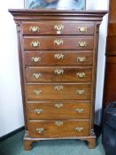 A GEORGIAN AND LATER IRISH MAHOGANY CHEST OF SEVEN GRADED DRAWERS BETWEEN QUARTER ROUND REEDED PILAS