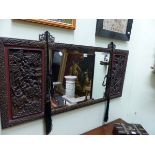 A BEVELLED GLASS RECTANGULAR MIRROR CENTRAL TO CHINESE HARDWOOD PANELS CARVED WITH WARRIORS ALL WITH