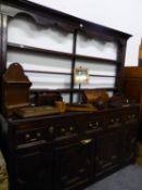 AN ANTIQUE OAK DRESSER WITH OPEN SHELF BACK, THE BASE WITH THREE DRAWERS ABOVE TWO CRUCIFORM PANELL