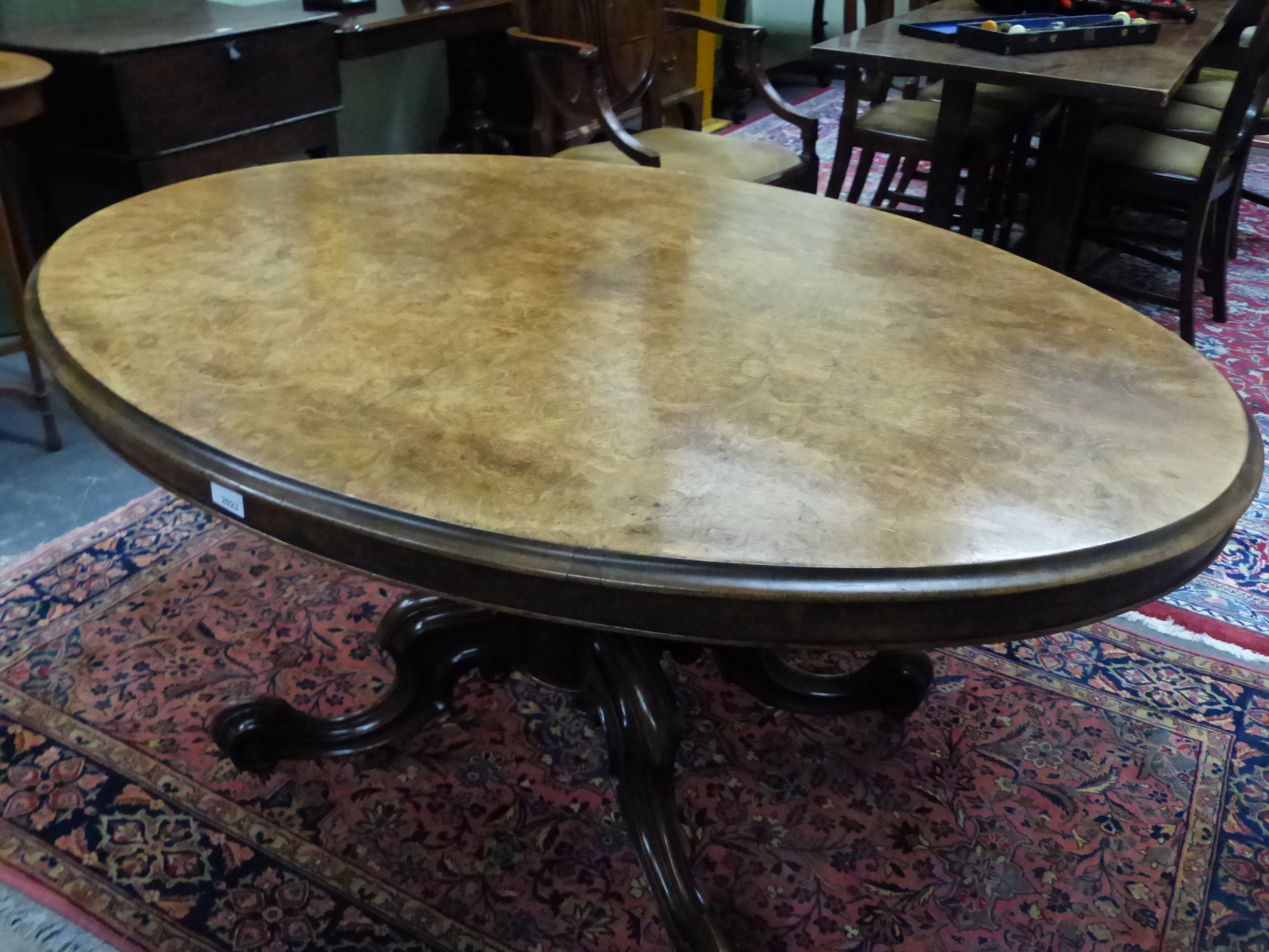 A VICTORIAN WALNUT OVAL TOP BREAKFAST TABLE ON CARVED QUADRUPED LEGS. W 101 X D 136 X H 71cms.