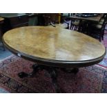 A VICTORIAN WALNUT OVAL TOP BREAKFAST TABLE ON CARVED QUADRUPED LEGS. W 101 X D 136 X H 71cms.