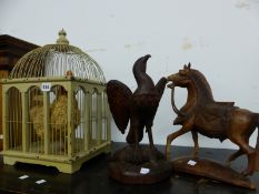A CARVED WOODEN HORSE AN EAGLE ON FISH CARVING AND AN ORNAMENTAL CHICKEN IN CAGE.