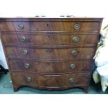 A GEORGE III MAHOGANY SERPENTINE FRONTED SECRETAIRE CHEST OF THREE GRADED LONG DRAWERS, THE WAVY