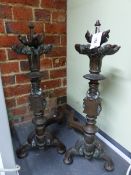 A PAIR OF ANTIQUE GOTHIC STYLE IRON BAR BACKED BRONZE ANDIRONS, THE FRONT COLUMNS WITH TWO TIER