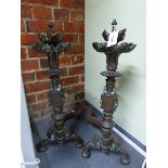 A PAIR OF ANTIQUE GOTHIC STYLE IRON BAR BACKED BRONZE ANDIRONS, THE FRONT COLUMNS WITH TWO TIER