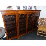 A MAHOGANY BREAKFRONT DISPLAY CABINET WITH FOUR LANCET ARCHED GLAZED DOORS ENCLOSING SHELVES ABOVE
