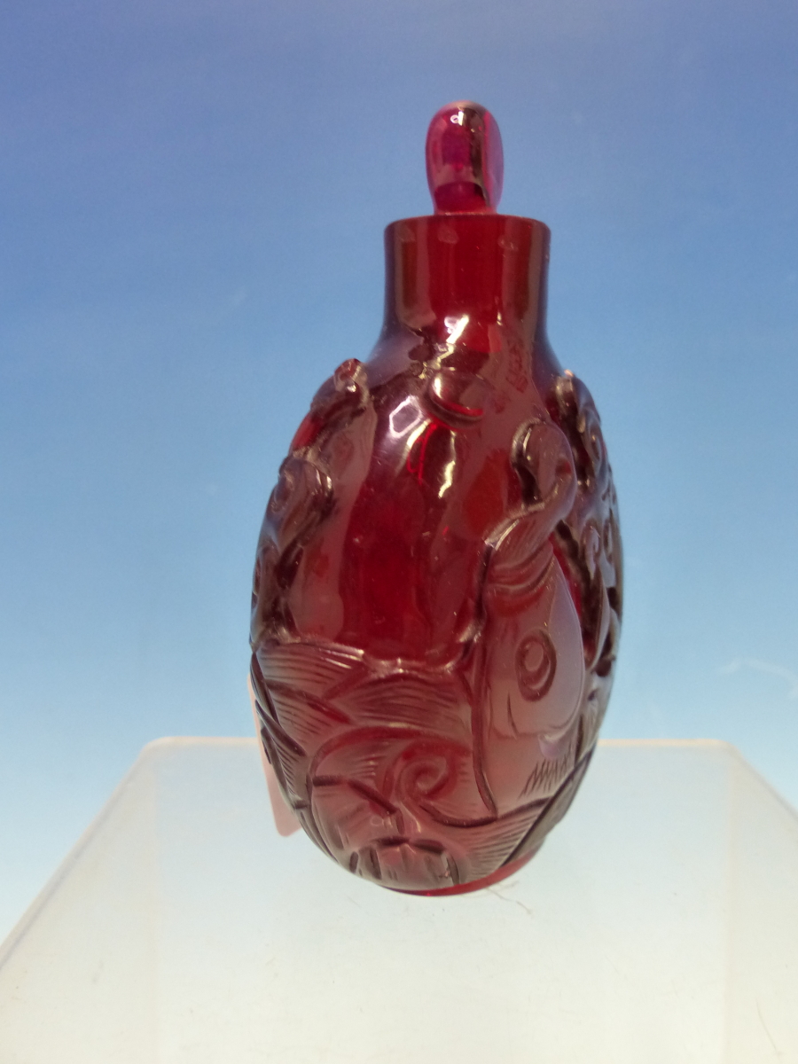 A CHINESE RUBY GLASS SNUFF BOTTLE WITH EUROPEAN STOPPER, EACH SIDE CARVED WITH A FISH ON ITS BACK - Bild 3 aus 6