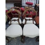 A MATCHED SET OF FOUR MAHOGANY BALLOON BACK CHAIRS, THE UPHOLSTERED SERPENTINE FRONTED SEATS ABOVE