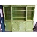 AN ANTIQUE APPLE GREEN PAINTED BREAKFRONT BOOK CASE, THE TOP WITH OPEN SHELVING BETWEEN REEDED PILAS
